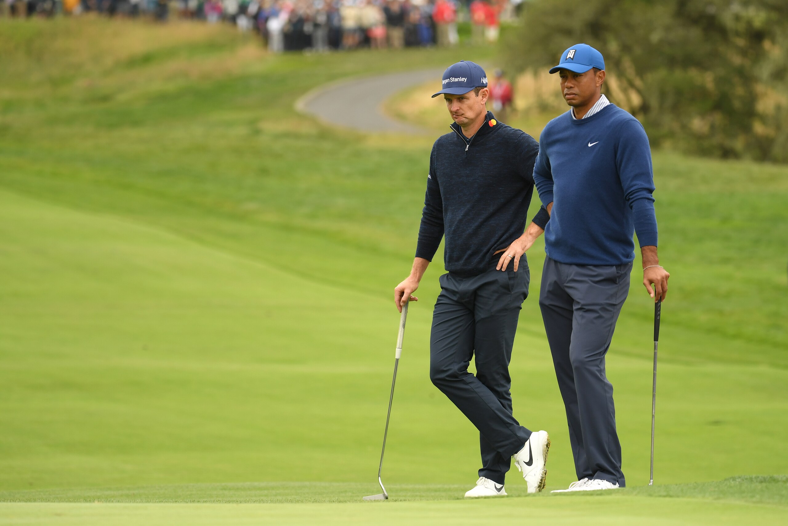 PEBBLE BEACH, CALIFORNIA - JUNE 14: Justin Rose of England (L) and Tiger Woods of the United States look on from the second green during the second round of the 2019 U.S. Open at Pebble Beach Golf Links on June 14, 2019 in Pebble Beach, California. (Photo by Ross Kinnaird/Getty Images)
