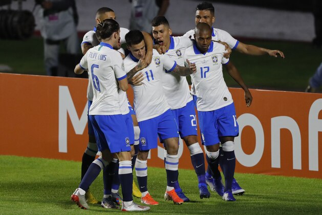 Brazil's Philippe Coutinho, center, celebrates scoring his side's opening goal with teammates during a Copa America Group A soccer match at the Morumbi stadium in Sao Paulo, Brazil, Friday, June 14, 2019. (AP Photo/Nelson Antoine)