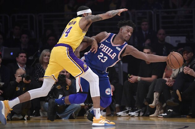 Los Angeles Lakers forward Brandon Ingram, left, and Philadelphia 76ers guard Jimmy Butler reach for a loose ball during the first half of an NBA basketball game Tuesday, Jan. 29, 2019, in Los Angeles. (AP Photo/Mark J. Terrill)