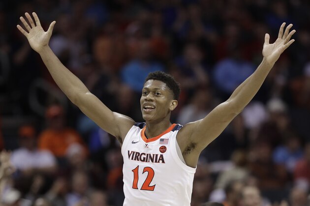Virginia's De'Andre Hunter (12) reacts after making a basket against North Carolina State during the second half of an NCAA college basketball game in the Atlantic Coast Conference tournament in Charlotte, N.C., Thursday, March 14, 2019. (AP Photo/Chuck Burton)