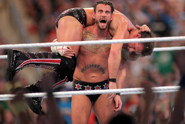 FILE - In this April 1, 2012, file photo, CM Punk competes against Chris Jericho at WrestleMania XXVIII in Sun Life Stadium in Miami Gardens, Fla. CM Punk making his debut as a mixed martial arts fighter on Saturday night in UFC 203. (AP Photo/AP Images for Wreslemania, Marc Serota, File)