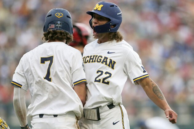 Michigan's Jesse Franklin (7) and Jordan Brewer (22) celebrate after scoring on Jimmy Kerr's two-run triple against Texas Tech in the third inning of an NCAA College World Series baseball game in Omaha, Neb., Saturday, June 15, 2019. (AP Photo/Nati Harnik)