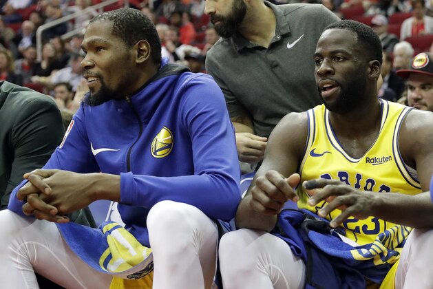 Golden State Warriors' Kevin Durant, left, and Draymond Green sit on the bench during the first half of an NBA basketball game against the Houston Rockets Thursday, Nov. 15, 2018, in Houston. (AP Photo/David J. Phillip)
