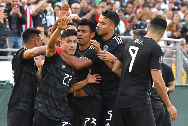 PASADENA, CA - JUNE 15:  Uriel Antuna #22 of Mexico is mobbed in celebration after scoring his team's first goal in the first half of the game against the Cuba at the Rose Bowl on June 15, 2019 in Pasadena, California. (Photo by Jayne Kamin-Oncea/Getty Images)