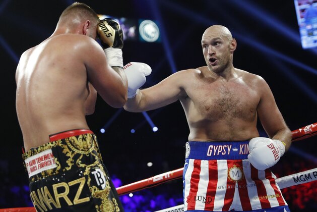 Tom Schwarz, of Germany, covers up during a heavyweight boxing match against Tyson Fury, of England, Saturday, June 15, 2019, in Las Vegas. (AP Photo/John Locher)