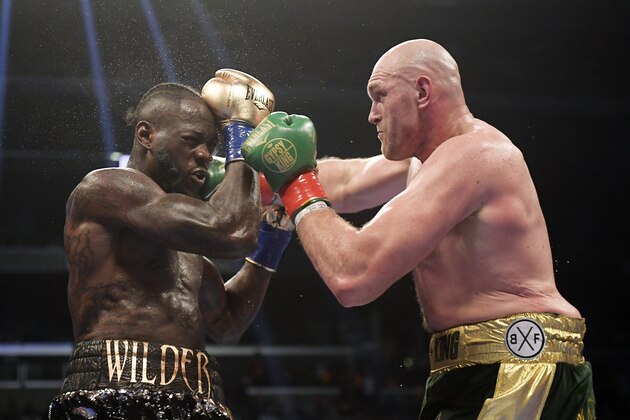 Tyson Fury, right, of England, connects with Deontay Wilder during a WBC heavyweight championship boxing match, Saturday, Dec. 1, 2018, in Los Angeles. (AP Photo/Mark J. Terrill)