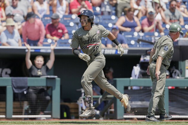 Vanderbilt's Austin Martin (16) celebrates his solo home run against Louisville in the first inning of an NCAA College World Series baseball game in Omaha, Neb., Sunday, June 16, 2019. (AP Photo/Nati Harnik)
