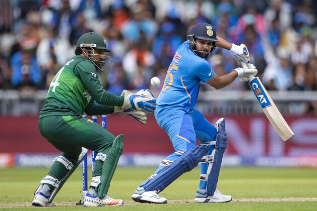 MANCHESTER, ENGLAND - JUNE 16: Rohit Sharma of India batting with Sarfaraz Ahmed keeping wicket for Pakistan during the Group Stage match of the ICC Cricket World Cup 2019 between Pakistan and India at Old Trafford on June 16, 2019 in Manchester, England. (Photo by Visionhaus/Getty Images)