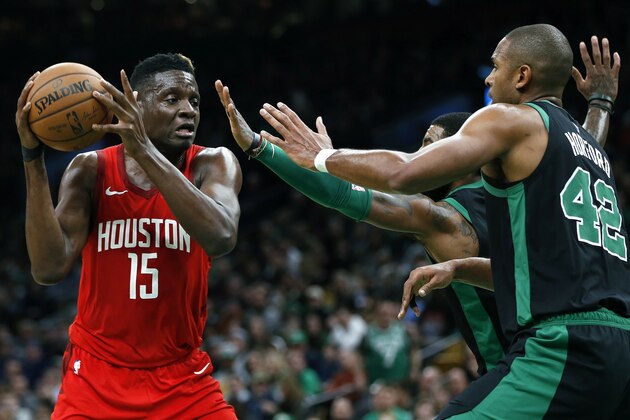 Boston Celtics' Kyrie Irving, back right, and Al Horford (42) double-team Houston Rockets' Clint Capela (15) during the second half of an NBA basketball game in Boston, Sunday, March 3, 2019. (AP Photo/Michael Dwyer)