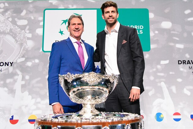 International Tennis Federation (ITF) president David Haggerty (L) and Barcelona's Spanish defender and Kosmos president Gerard Pique pose with the trophy after the draw for the 2019 Davis Cup tennis finals in Madrid on February 14, 2019. (Photo by JAVIER SORIANO / AFP)        (Photo credit should read JAVIER SORIANO/AFP/Getty Images)