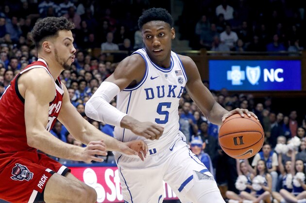 Duke's RJ Barrett (5) drives against North Carolina State's Devon Daniels (24) during the second half of an NCAA college basketball game in Durham, N.C., Saturday, Feb. 16, 2019. (AP Photo/Chris Seward)