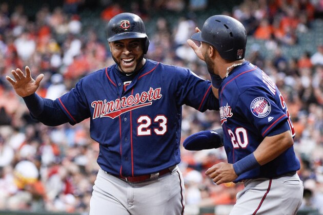 Minnesota Twins' Nelson Cruz (23) and Eddie Rosario celebrate after scoring on C.J. Cron's RBI-double during the first inning of a baseball game against the Houston Astros, Monday, April 22, 2019, in Houston. (AP Photo/Eric Christian Smith)