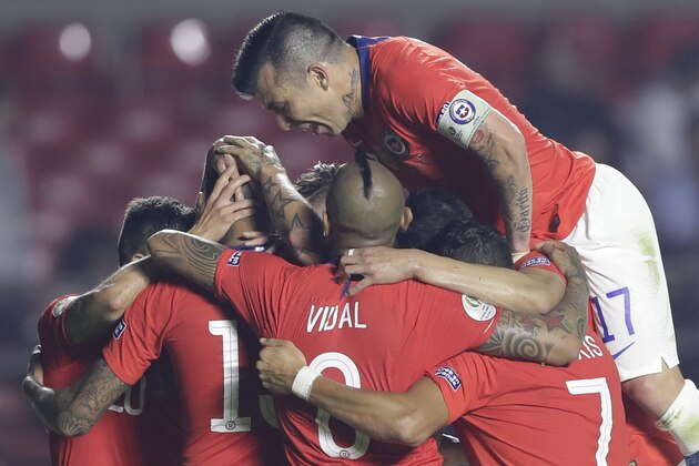 Chile's Gary Medel jumps over teammates congratulating Erick Pulgar for scoring his side's opening goal against Japan during a Copa America Group C soccer match at the Morumbi stadium in Sao Paulo, Brazil, Monday, June 17, 2019. (AP Photo/Andre Penner)