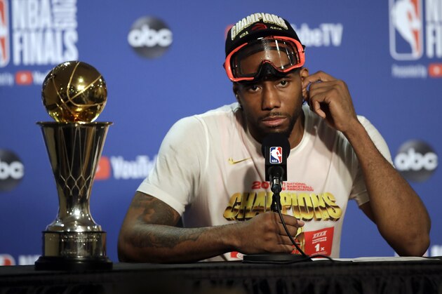 Toronto Raptors forward Kawhi Leonard speaks at a news conference alongside the NBA Finals Most Valuable Player trophy after the Raptors defeated the Golden State Warriors in Game 6 of basketball's NBA Finals in Oakland, Calif., Thursday, June 13, 2019. (AP Photo/Ben Margot)