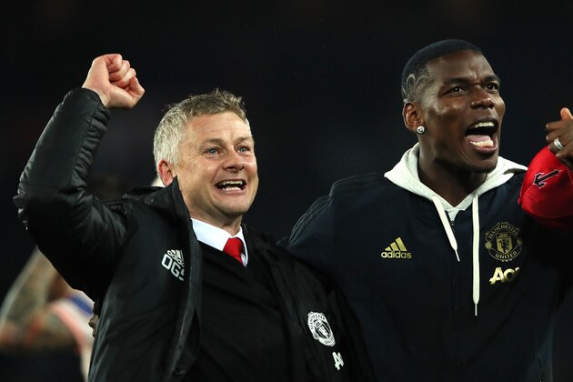 PARIS, FRANCE - MARCH 06:  Manchester United Head Coach / Manager Ole Gunnar Solskjaer and Paul Pogba of Manchester United celebrate at the end of the UEFA Champions League Round of 16 Second Leg match between Paris Saint-Germain and Manchester United at Parc des Princes on March 6, 2019 in Paris, France. (Photo by Matthew Ashton - AMA/Getty Images)