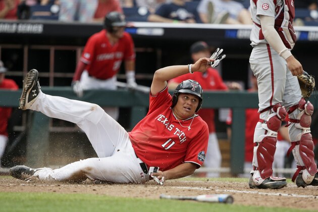 Texas Tech's Cameron Warren (11) scores the go-ahead and winning run against Arkansas on a triple by Cody Masters in the eighth inning of an NCAA College World Series baseball game in Omaha, Neb., Monday, June 17, 2019. (AP Photo/Nati Harnik)