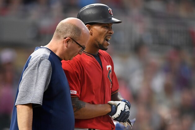 MINNEAPOLIS, MN - JUNE 14: Byron Buxton #25 of the Minnesota Twins reacts to being hit by a pitch as trainer Tony Leo checks on him during the sixth inning of the game against the Kansas City Royals on June 14, 2019 at Target Field in Minneapolis, Minnesota. The Twins defeated the Royals 2-0. (Photo by Hannah Foslien/Getty Images)