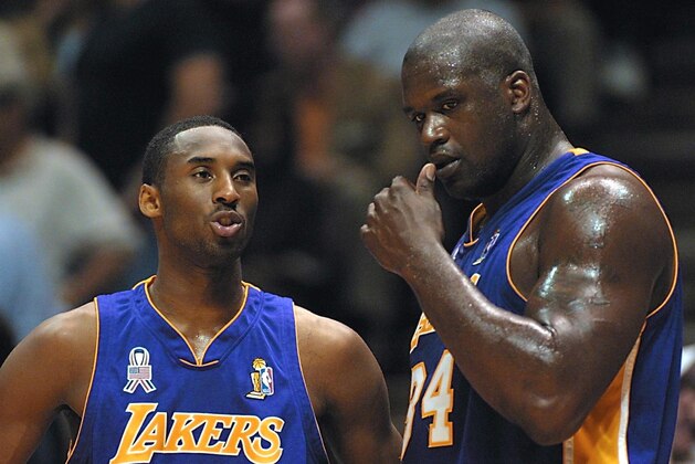 EAST RUTHERFORD, UNITED STATES:  Kobe Bryant (L) and Shaquille O'Neal of the Los Angeles Lakers talk during game four of the NBA Finals against the New Jersey Nets at the Continental Airlines Arena 12 June 2002 in East Rutherford, NJ. The Lakers, led by O'Neal, swept to their third straight National Basketball Association championship with a 113-107 victory over the Nets. AFP PHOTO/Matt CAMPBELL (Photo credit should read MATT CAMPBELL/AFP/Getty Images)