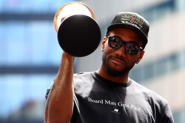 TORONTO, ON - JUNE 17:  Kawhi Leonard #2 of the Toronto Raptors holds the MVP trophy during the Toronto Raptors Victory Parade on June 17, 2019 in Toronto, Canada. The Toronto Raptors beat the Golden State Warriors 4-2 to win the 2019 NBA Finals.  NOTE TO USER: User expressly acknowledges and agrees that, by downloading and or using this photograph, User is consenting to the terms and conditions of the Getty Images License Agreement.  (Photo by Vaughn Ridley/Getty Images)