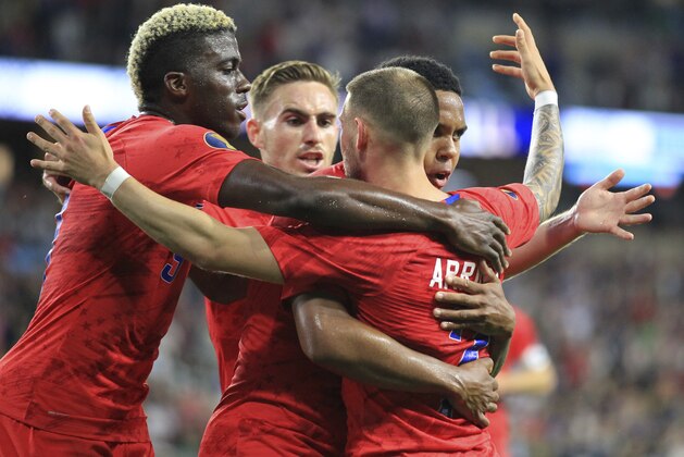 United States' Paul Arriola (7) celebrates with teammates Gyasi Zardes, left, Tyler Boyd, center and Weston Mckennie, back right, after scoring a goal on Guyana goalie Akel Clarke during the first half of a CONCACAF Gold Cup soccer match Tuesday, June 18, 2019, in St. Paul, Minn. (AP Photo/Andy Clayton-King)