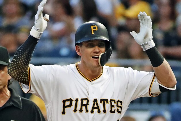 Pittsburgh Pirates' Kevin Newman celebrates as he stands on first base after driving in two runs with a single off Milwaukee Brewers relief pitcher Freddy Peralta during the third inning of a baseball game in Pittsburgh, Friday, May 31, 2019. (AP Photo/Gene J. Puskar)
