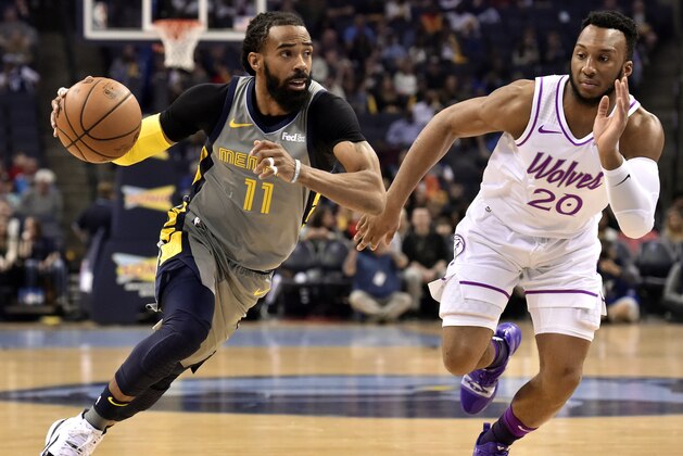 Memphis Grizzlies guard Mike Conley (11) handles the ball against Minnesota Timberwolves guard Josh Okogie (20) in the first half of an NBA basketball game Saturday, March 23, 2019, in Memphis, Tenn. (AP Photo/Brandon Dill)