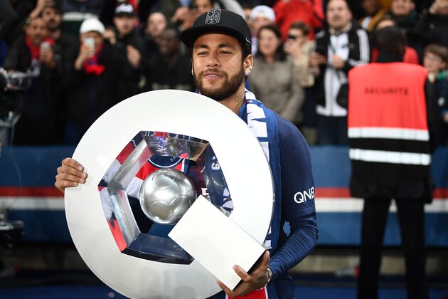 Paris Saint-Germain's Brazilian forward Neymar celebrates with the champion's trophy at the end of the French L1 football match between Paris Saint-Germain (PSG) and Dijon at the Parc des Princes stadium in Paris on May 18, 2019. (Photo by FRANCK FIFE / AFP)        (Photo credit should read FRANCK FIFE/AFP/Getty Images)