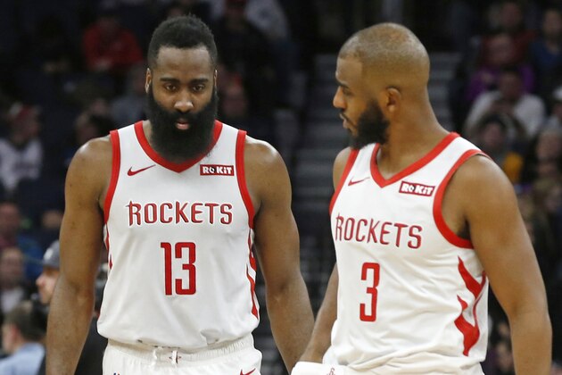 Houston Rockets' James Harden, left, and Chris Paul confer in an NBA basketball game against the Minnesota Timberwolves Wednesday, Feb. 13, 2019, in Minneapolis. (AP Photo/Jim Mone)