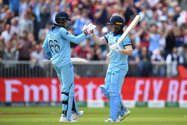 MANCHESTER, ENGLAND - JUNE 18: Eoin Morgan of England celebrates his century with Joe Root of England during the Group Stage match of the ICC Cricket World Cup 2019 between England and Afghanistan at Old Trafford on June 18, 2019 in Manchester, England. (Photo by Clive Mason/Getty Images)