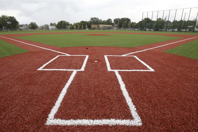 This Thursday, Aug. 21, 2014 photo shows the restored field at League Park in Cleveland. The city of Cleveland has invested $6.3 million in restoring the old site of League Park, a historic site where the Cleveland Indians clinched its 1920 World Series title, Babe Ruth hit his 500th home run and where Joe DiMaggio extended his hitting streak to 56 games. Not much of the old ballbark, where Cy Young threw the first pitch in 1891 remains, but the new park will host high school and youth games on its all-turf field and will pay homage to the greats who once played there. (AP Photo/Tony Dejak)