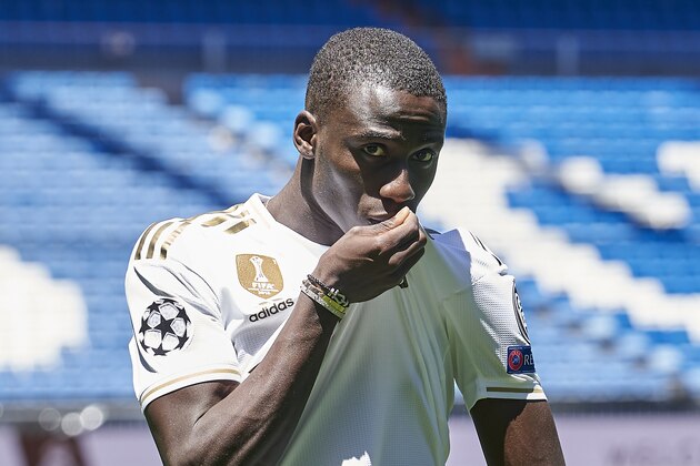 French defender Ferland Mendy (L) and Real Madrid's president Florentino Perez pose during the official presentation of the footballer as new player of the Spanish club at the Santiago Bernabeu stadium in Madrid on June 19, 2019. (Photo by OSCAR DEL POZO / AFP)        (Photo credit should read OSCAR DEL POZO/AFP/Getty Images)