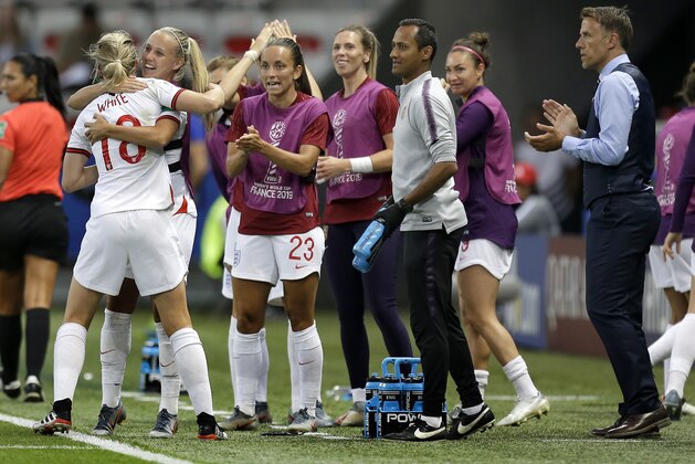 England head coach Philip Neville, right, applaudes as England's scorer Ellen White, left, and her teammates celebrate the opening goal during the Women's World Cup Group D soccer match between Japan and England at the Stade de Nice in Nice, France, Wednesday, June 19, 2019. (AP Photo/Claude Paris)