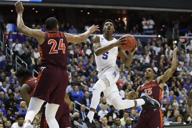 FILE - In this March 29, 2019, file photo, Duke forward RJ Barrett (5) drives to the basket past Virginia Tech forward Kerry Blackshear Jr. (24) and guard Ahmed Hill (13) during the second half of an NCAA men's East Regional semifinal college basketball game, in Washington. Barrett is leaving Duke after one season to enter the NBA draft. Barrett announced his decision Wednesday, April 10, 2019, in a video posted on social media. He calls playing at Duke a dream and adds that “it’s also a dream of mine to play in the NBA and have great success there.”(AP Photo/Alex Brandon, File)