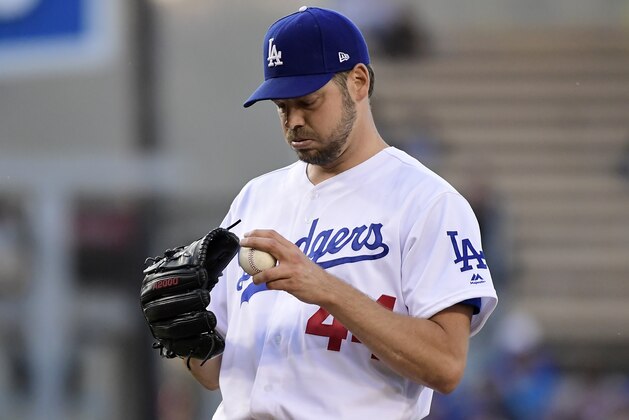 Los Angeles Dodgers' Rich Hill gets set to pitch during the first inning of the team's baseball game against the San Francisco Giants on Wednesday, June 19, 2019, in Los Angeles. (AP Photo/Mark J. Terrill)