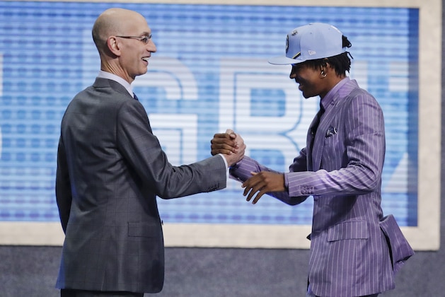 Murray State's Ja Morant, right, is greeted by NBA Commissioner Adam Silver after being selected by the Memphis Grizzlies with the second pick in the NBA basketball draft Thursday, June 20, 2019, in New York. (AP Photo/Julio Cortez)