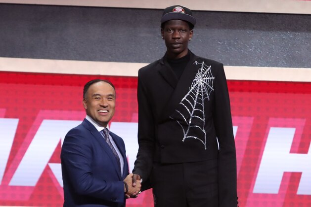BROOKLYN, NY - JUNE 20: Bol Bol shakes hands with NBA Deputy Commissioner Mark Tatum after being selected number forty four overall by the Miami Heat during the 2019 NBA Draft on June 20, 2019 at Barclays Center in Brooklyn, New York. NOTE TO USER: User expressly acknowledges and agrees that, by downloading and or using this photograph, User is consenting to the terms and conditions of the Getty Images License Agreement. Mandatory Copyright Notice: Copyright 2019 NBAE (Photo by Nathaniel S. Butler/NBAE via Getty Images)