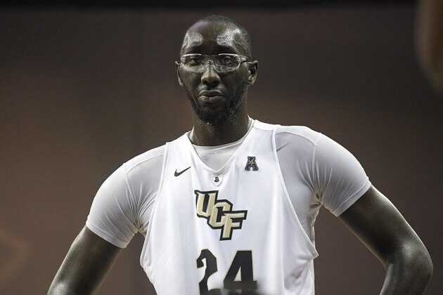 Central Florida center Tacko Fall (24) listens to instructions during a timeout in the second half of an NCAA college basketball game against Cincinnati Tuesday, Jan. 16, 2018, in Orlando, Fla. Cincinnati won 49-38. (AP Photo/Phelan M. Ebenhack)