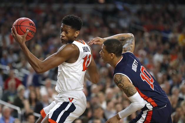 Virginia guard De'Andre Hunter, left, drives around Auburn guard Samir Doughty during the first half in the semifinals of the Final Four NCAA college basketball tournament, Saturday, April 6, 2019, in Minneapolis. (AP Photo/Jeff Roberson)