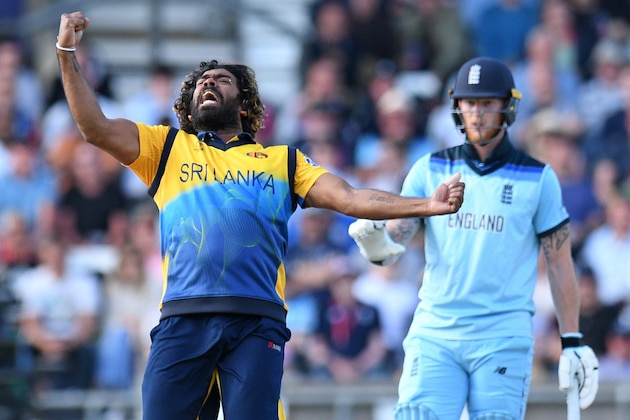 England's Ben Stokes (R) reacts as Sri Lanka's Lasith Malinga celebrates taking the wicket of England's Jos Buttler for 10 runs during the 2019 Cricket World Cup group stage match between England and Sri Lanka at Headingley in Leeds, northern England, on June 21, 2019. (Photo by Oli SCARFF / AFP) / RESTRICTED TO EDITORIAL USE        (Photo credit should read OLI SCARFF/AFP/Getty Images)