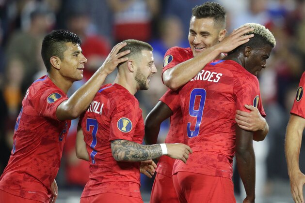 United States' Gyasi Zardes (9) is congratulated by, left to right, Nick Lima, Paul Arriola and Aaron Long after Zardes scored a goal off a deflection by a Guyana player that went off his face into the goal during the second half of a CONCACAF Gold Cup soccer match Tuesday, June 18, 2019, in St. Paul, Minn. (AP Photo/Andy Clayton-King)