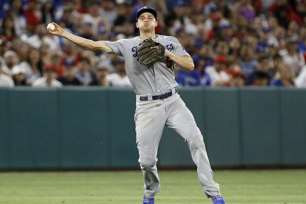 Los Angeles Dodgers shortstop Corey Seager throws, but not in time to get Los Angeles Angels' Kole Calhoun on an infield single during the fourth inning of a baseball game in Anaheim, Calif., Monday, June 10, 2019. (AP Photo/Alex Gallardo)