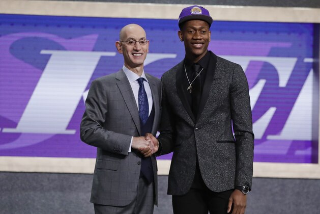 Virginia's De'Andre Hunter, right, is greeted by NBA Commissioner Adam Silver after being selected with the fourth pick overall by the Los Angeles Lakers during the NBA basketball draft Thursday, June 20, 2019, in New York. (AP Photo/Julio Cortez)