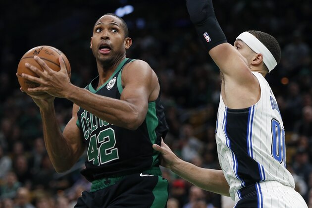 Boston Celtics' Al Horford (42) looks to shoot against Orlando Magic's Aaron Gordon (00) during the first half of an NBA basketball game in Boston, Sunday, April 7, 2019. (AP Photo/Michael Dwyer)