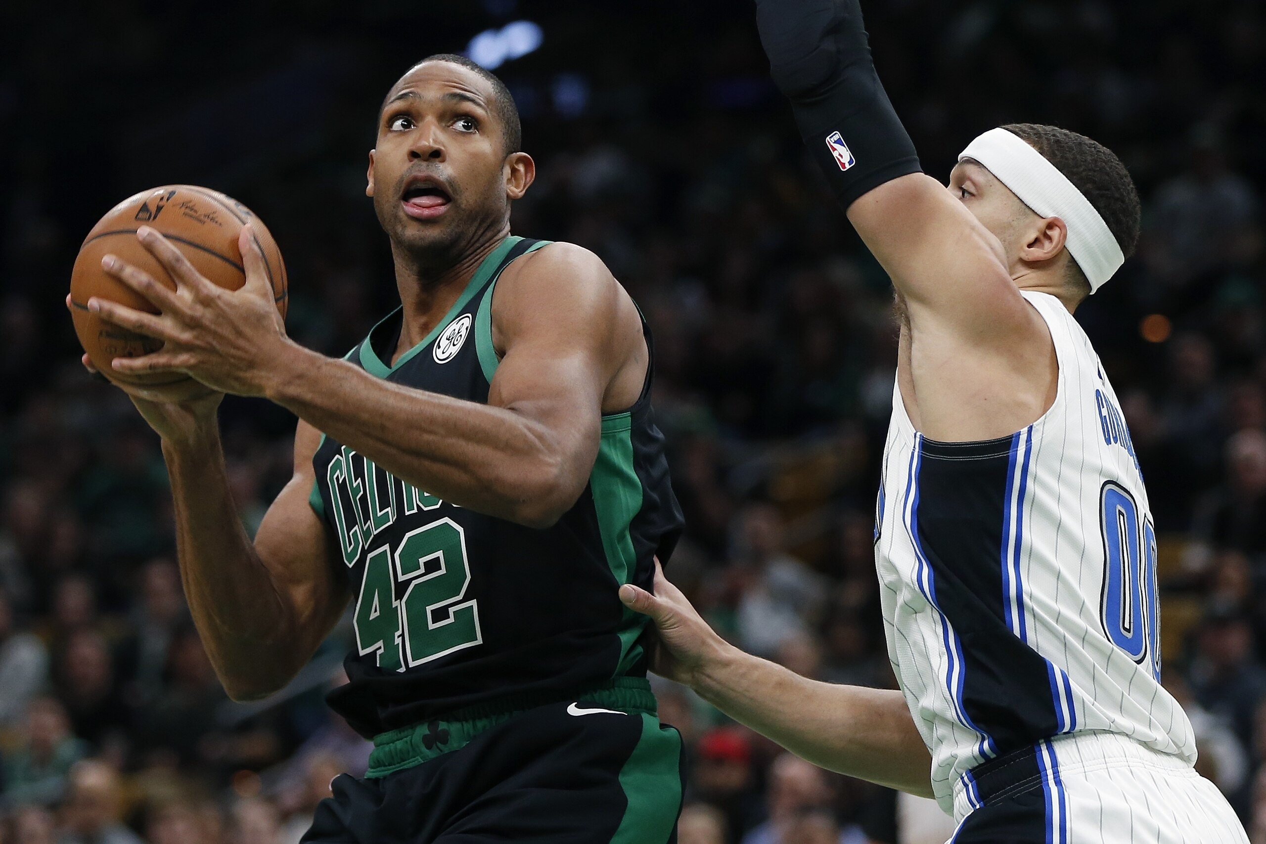 Boston Celtics' Al Horford (42) looks to shoot against Orlando Magic's Aaron Gordon (00) during the first half of an NBA basketball game in Boston, Sunday, April 7, 2019. (AP Photo/Michael Dwyer)