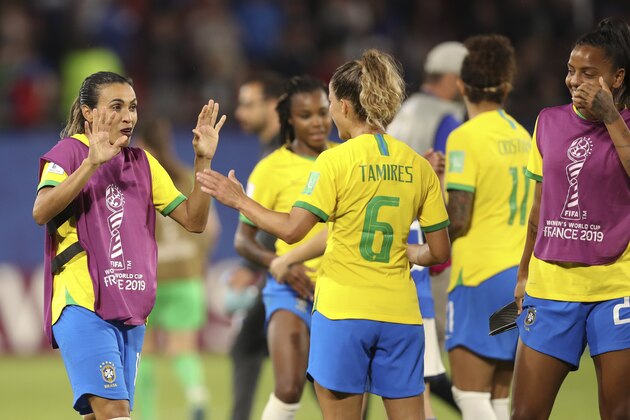 Brazil's Marta, left, celebrates with her teammates at the end of the Women's World Cup Group C soccer match between Italy and Brazil at the Stade du Hainaut in Valenciennes, France, Tuesday, June 18, 2019. Brazil beat Italy 1-0. (AP Photo/Francisco Seco)