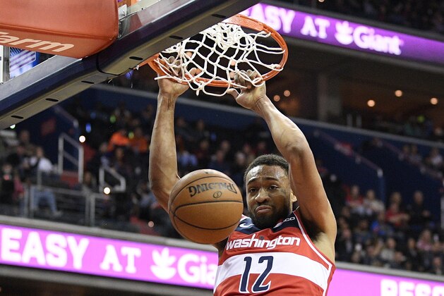 Washington Wizards forward Jabari Parker (12) dunks against Minnesota Timberwolves guard Josh Okogie (20) during the second half of an NBA basketball game, Sunday, March 3, 2019, in Washington. The Wizards won 135-121. (AP Photo/Nick Wass)