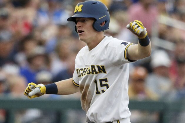 Michigan's Jimmy Kerr (15) celebrates at third base after hitting a two-run triple against Texas Tech in the third inning of an NCAA College World Series baseball game in Omaha, Neb., Saturday, June 15, 2019. Jesse Franklin and Jordan Brewer scored on the play. (AP Photo/Nati Harnik)