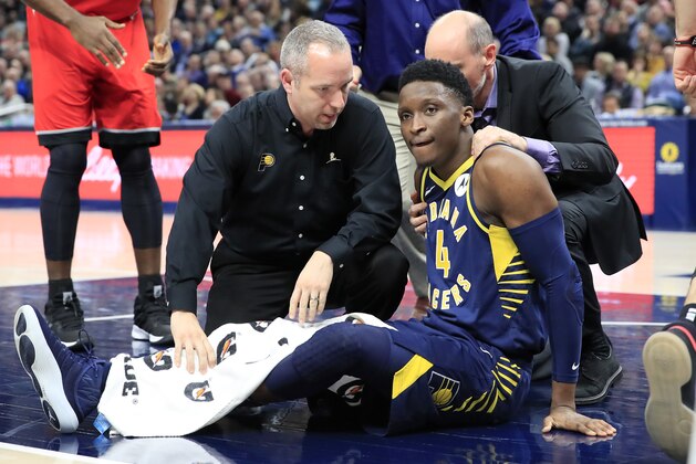 INDIANAPOLIS, INDIANA - JANUARY 23:  Victor Oladipo #4 of the Indiana Pacers is attended to by medical staff after being injured in the second quarter of the game against the Toronto Raptors  at Bankers Life Fieldhouse on January 23, 2019 in Indianapolis, Indiana. (Photo by Andy Lyons/Getty Images)