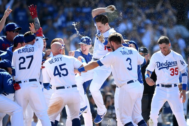 LOS ANGELES, CALIFORNIA - JUNE 23:  Will Smith #16 of the Los Angeles Dodgers jumps at home plate in celebration of his walk-off two run homerun, for a 5-3 win over the Colorado Rockies, during the ninth inning at Dodger Stadium on June 23, 2019 in Los Angeles, California. (Photo by Harry How/Getty Images)