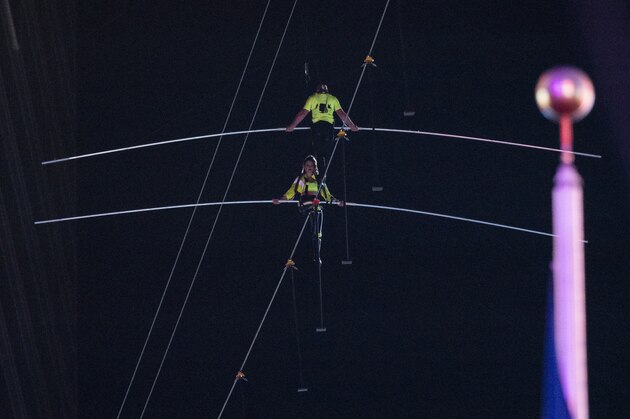 Nik Wallenda (R) and Lijana Wallenda walk a high wire over Times Square during the Highwire Live In Times Square With Nik Wallenda June 23, 2019 in New York City. (Photo by Johannes EISELE / AFP)        (Photo credit should read JOHANNES EISELE/AFP/Getty Images)